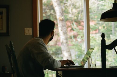 man sitting at computer desk